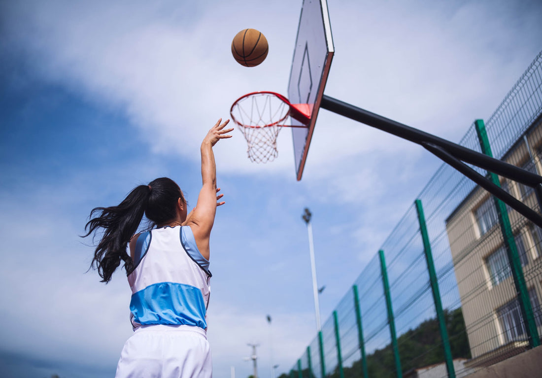 A lady athlete playing basket ball with good eye sights